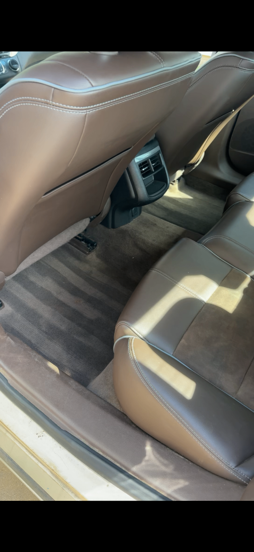Cleaned brown leather seats and detailed rear floor carpet
