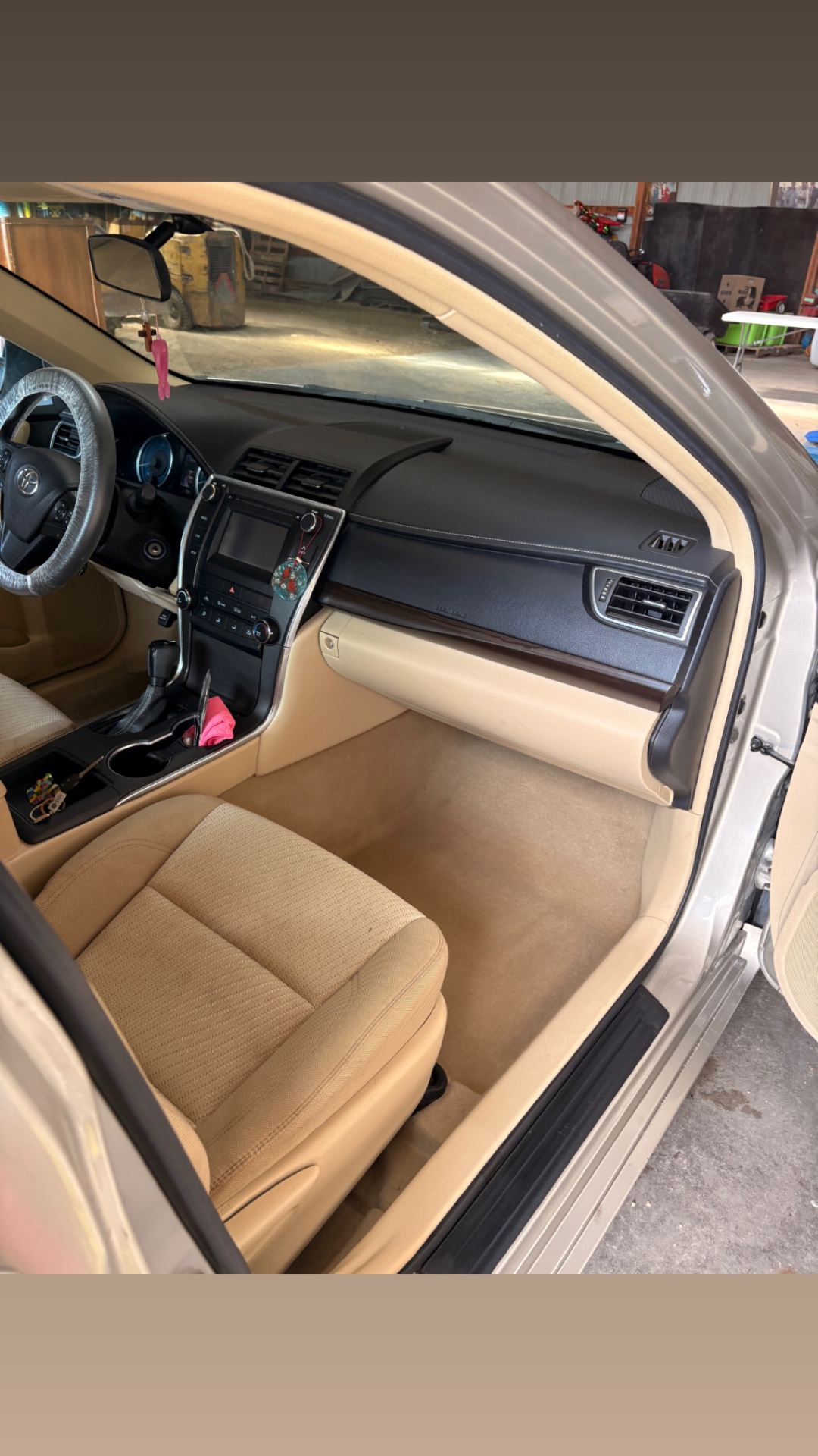 Detailed Toyota Camry interior with clean beige seats and carpet