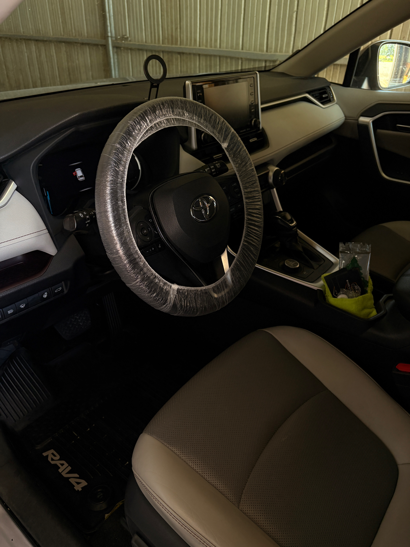 Detailed Toyota RAV4 interior with protected steering wheel and clean seats